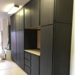 a wall of dark-colored built-in cabinets,
