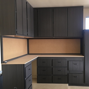 custom garage workbench with integrated cabinets and a pegboard