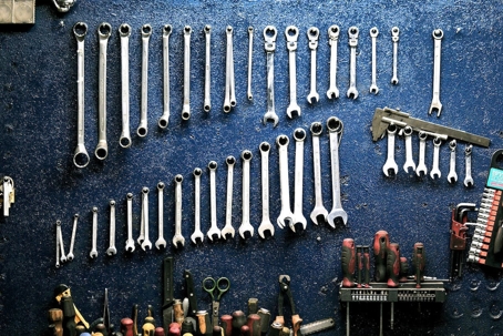 Tools hang on a blue wall